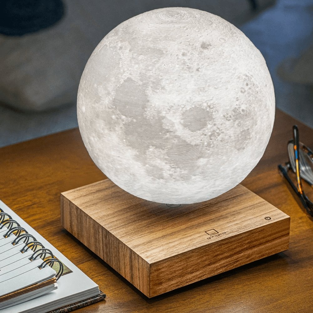 Floating moon shaped light on wooden stand