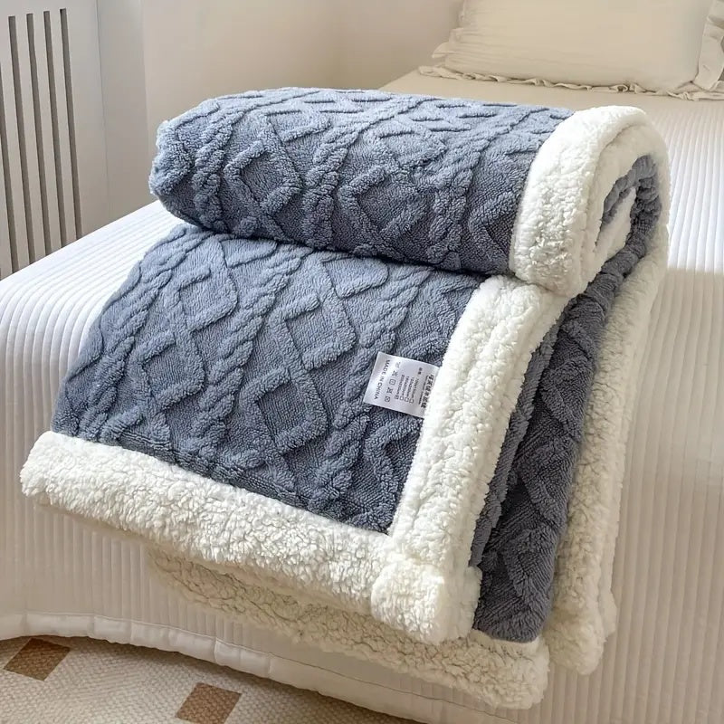 Reversible textured blanket with geometric pattern