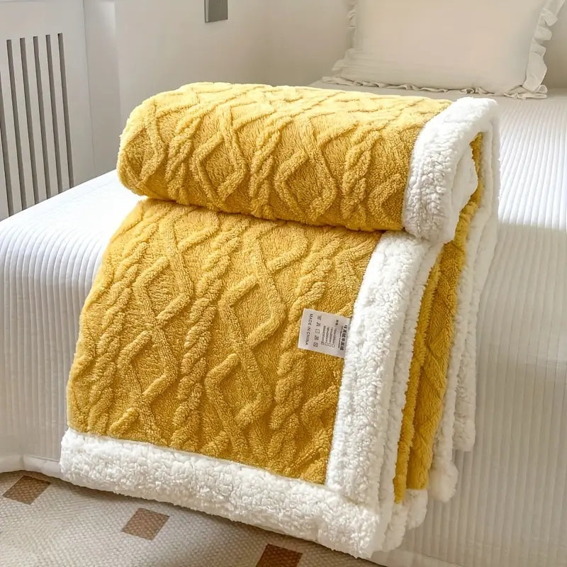 Reversible textured blanket with geometric pattern