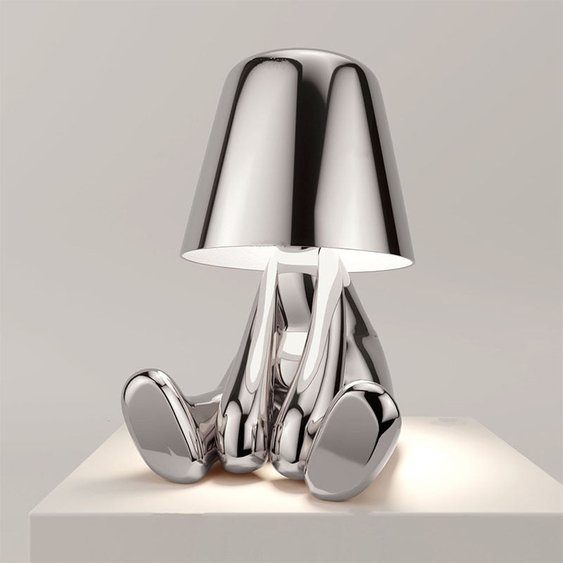 Metallic table light with reflective artistic form