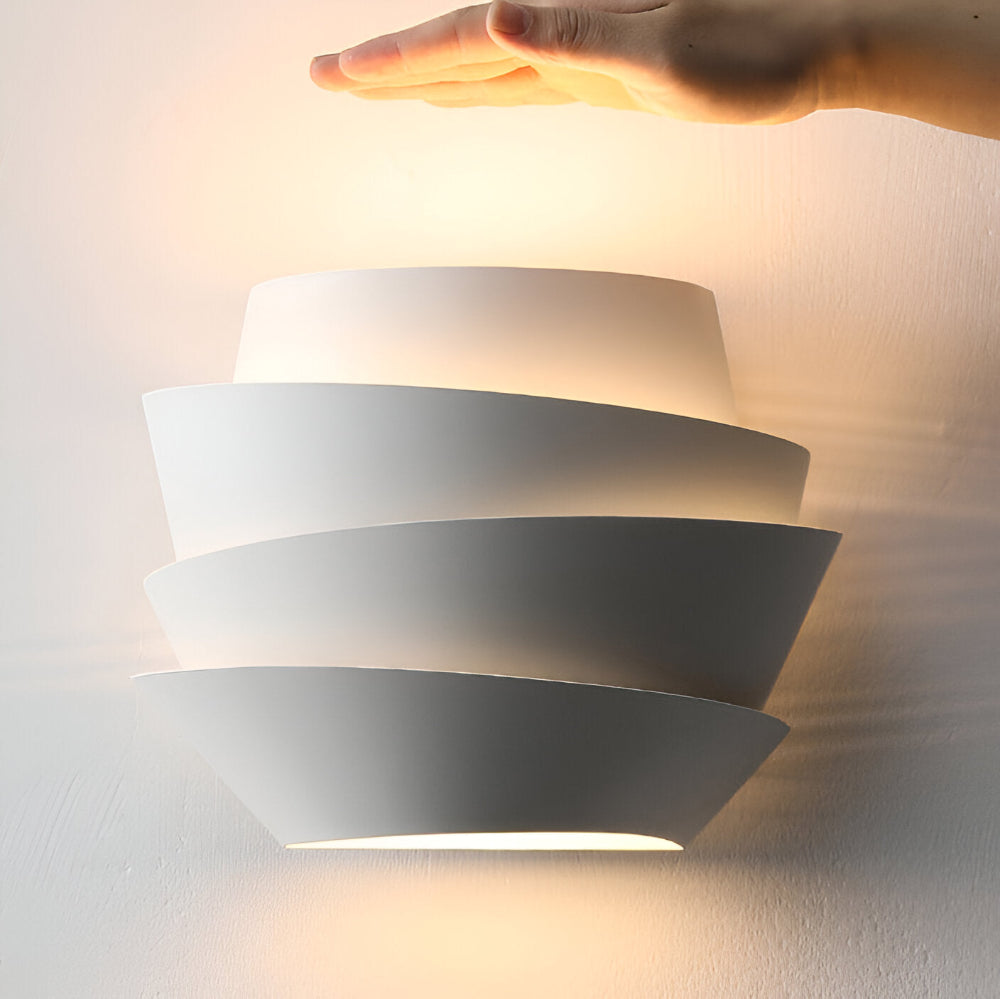 Modern wall lamp with overlapping curved panels