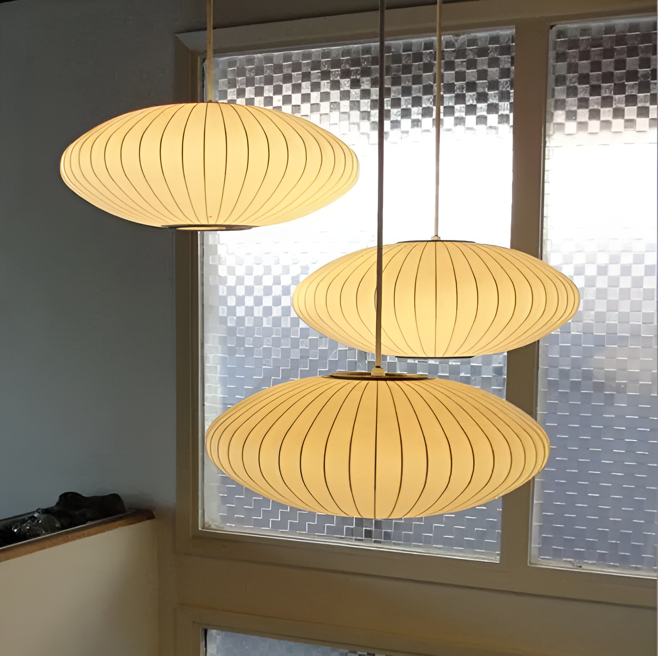 Oval pendant light with vertical lined shade