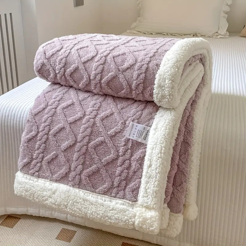Reversible textured blanket with geometric pattern