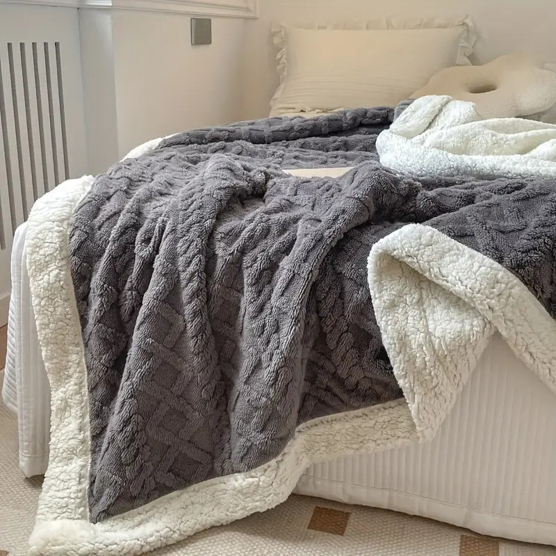 Reversible textured blanket with geometric pattern
